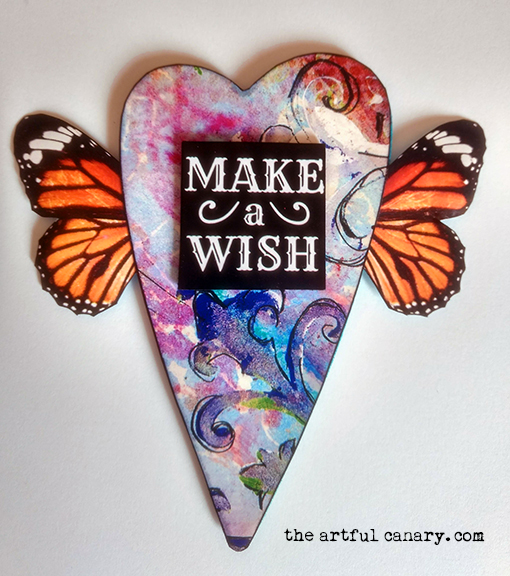 A picture of a heart with butterfly wings that says Make A Wish.